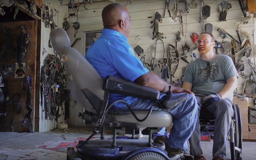 James Sullivan speaks with another individual while documenting disability in the developing world.