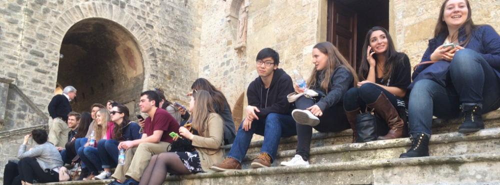 Students sitting on stone steps.