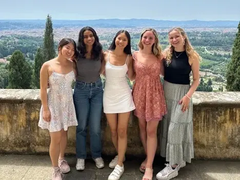 Group of 5 students posing on the Villa's terrace with view of Florence in the background.