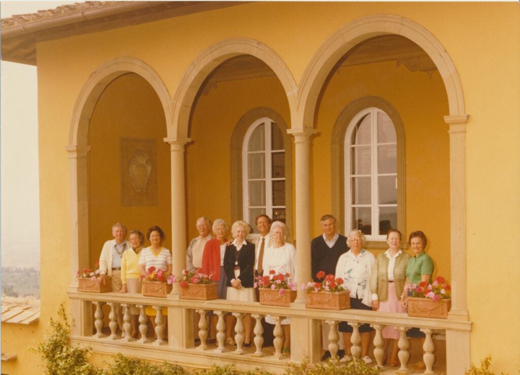 Group of 12 Georgetown alumni standing on the Villa's small terrace.