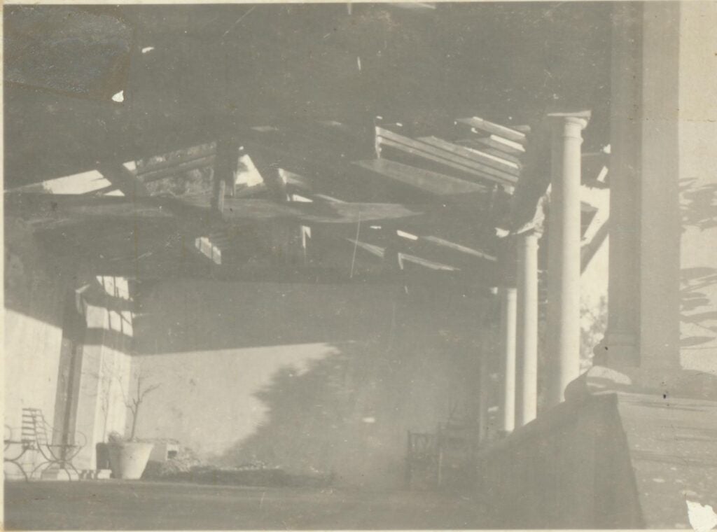 Black and white photo showing damage to the Loggia roof from WWII.